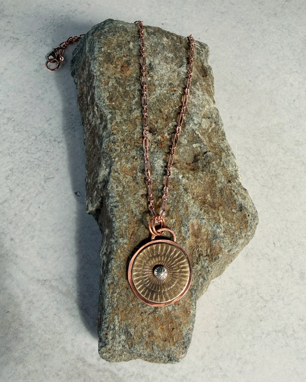 Mixed metal sunburst pendant