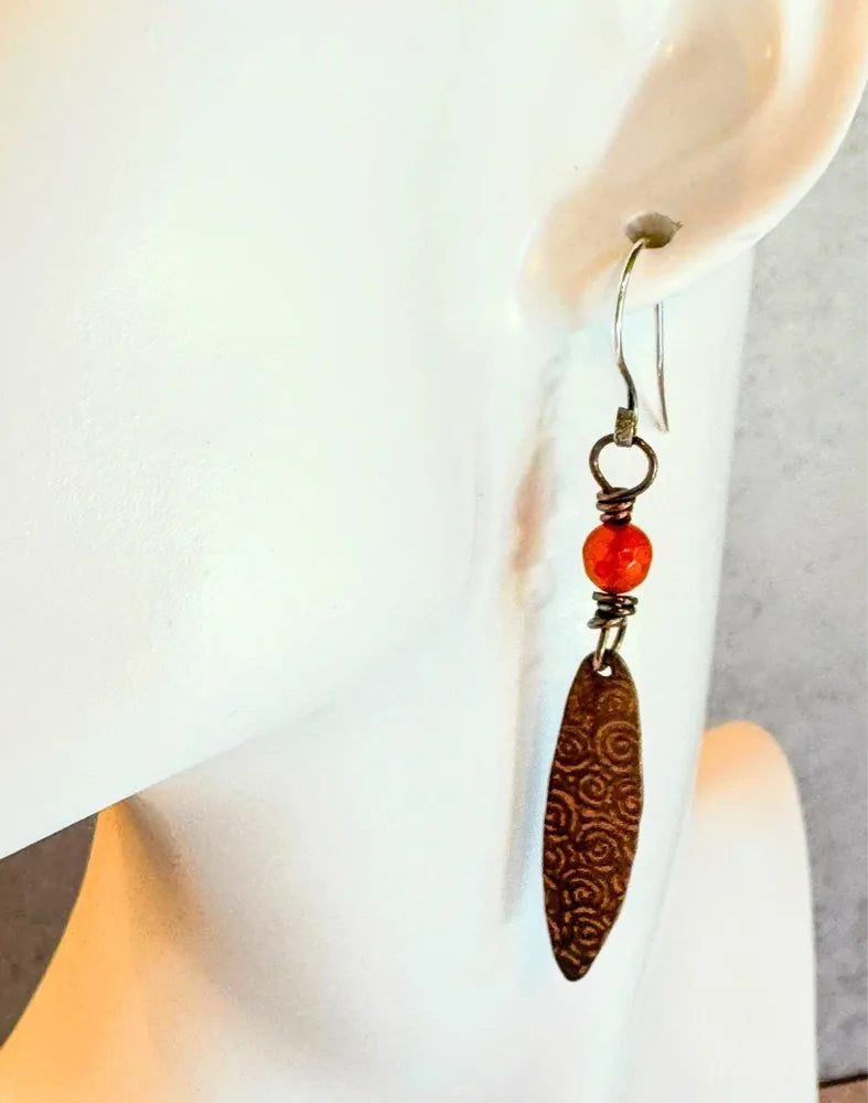 Long copper oval with spiral pattern