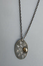 Matte silver and brass oval sun ray necklace