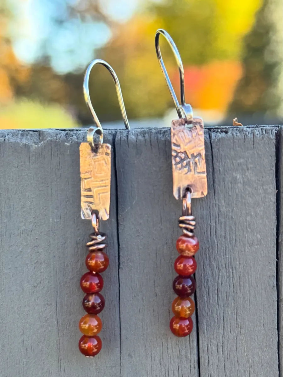 Textured copper rectangles with five carnelian beads