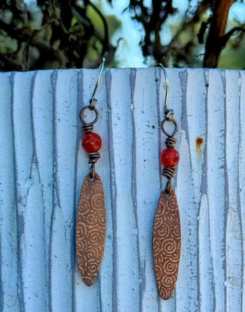 Long copper oval with spiral pattern