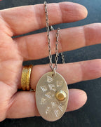 Matte silver and brass oval sun ray necklace