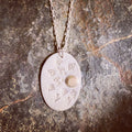 Matte silver and brass oval sun ray necklace