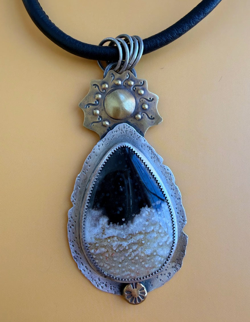 Petrified Palmwood in silver with bronze sun