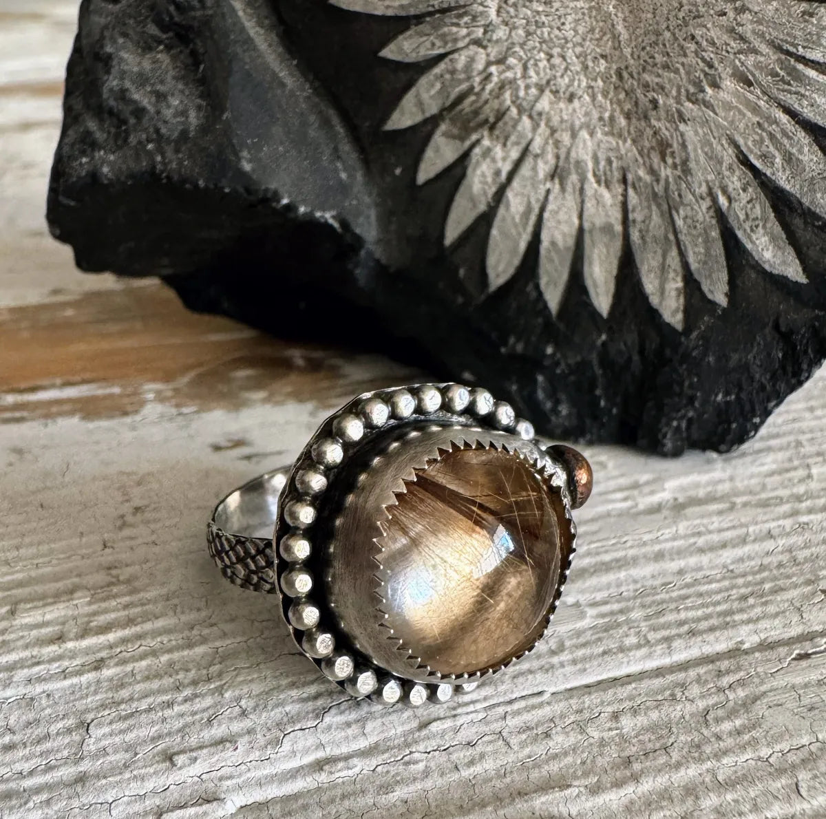 Rutilated quartz ring with bronze accent