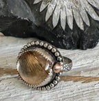 Rutilated quartz ring with bronze accent