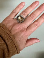 Rutilated quartz ring with bronze accent